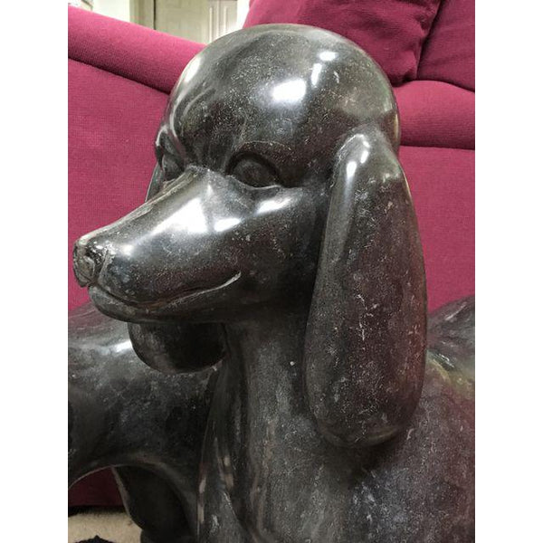 Pair of black marble poodle statues close up
