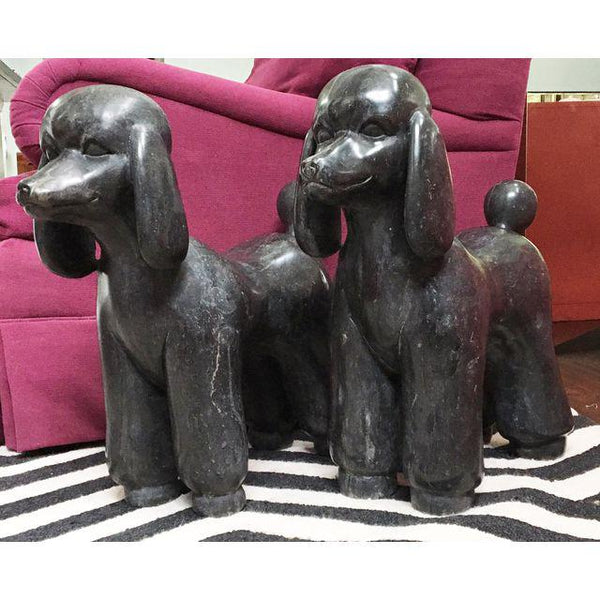 Pair of black marble poodle statues side view